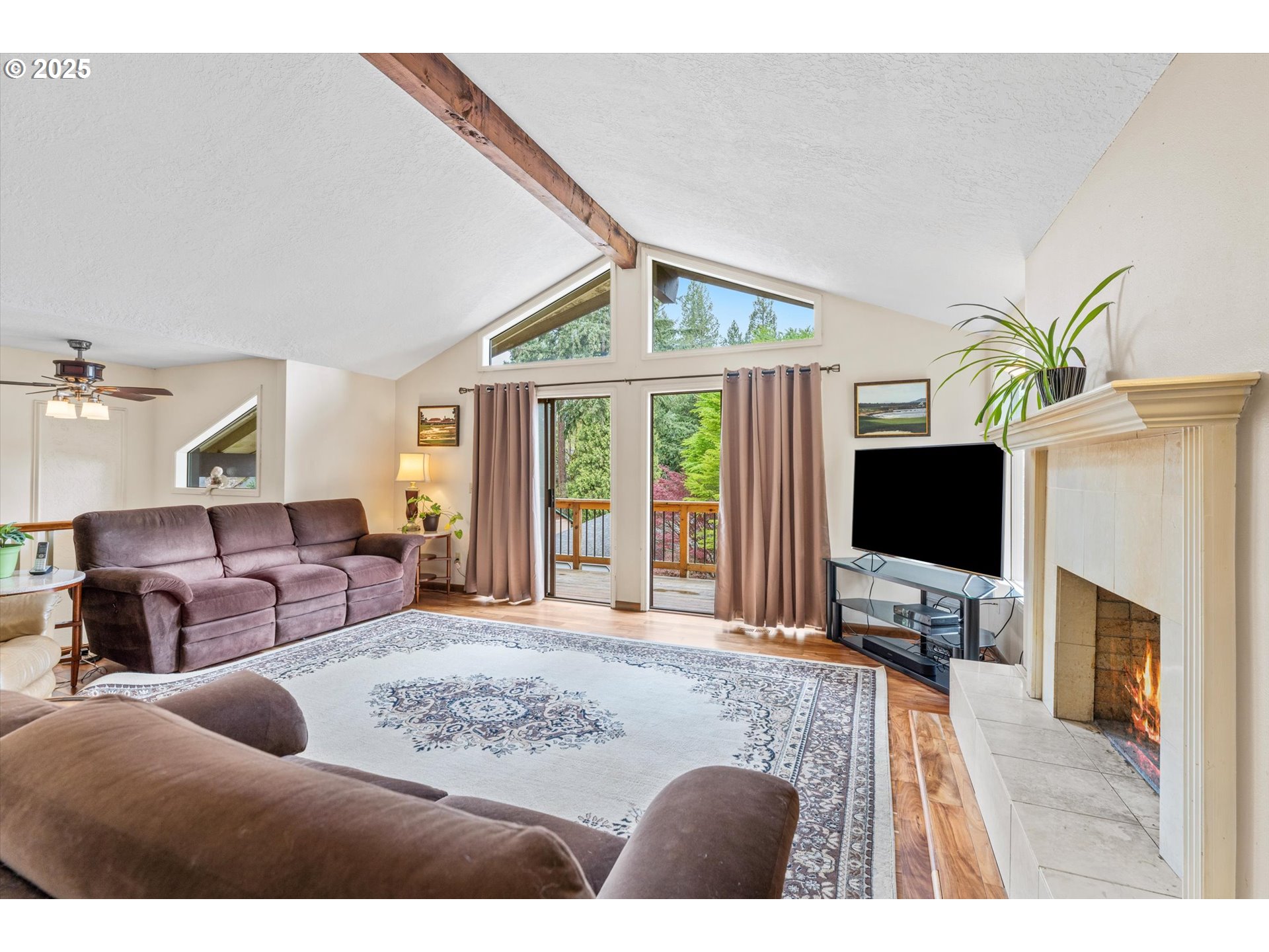 756 Southeast 27th Street Gresham, OR 97080 - Photo 4 of 46 a living room with furniture a flat screen tv and a fireplace