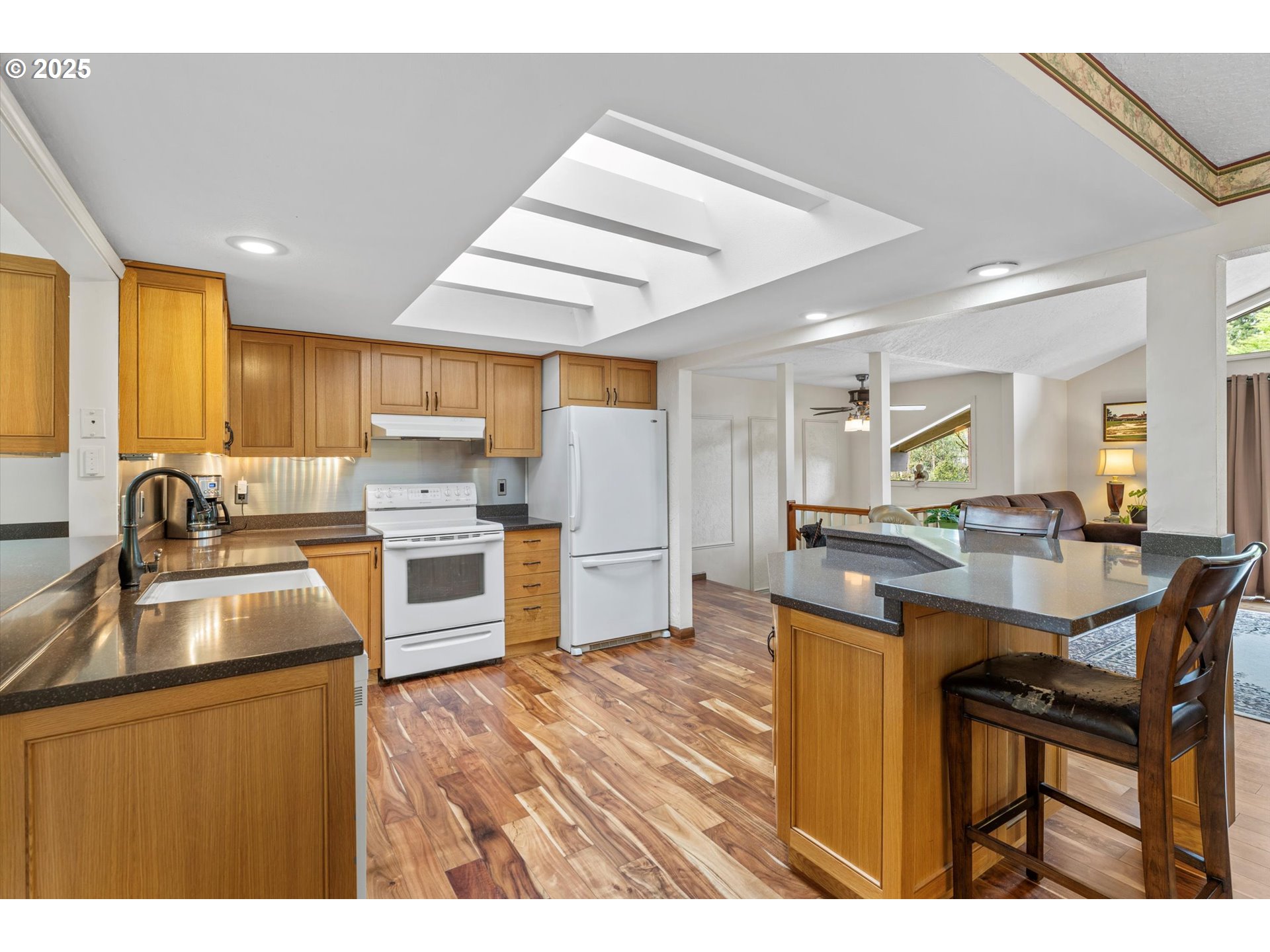 756 Southeast 27th Street Gresham, OR 97080 - Photo 8 of 46 a kitchen with stainless steel appliances kitchen island granite countertop a sink and cabinets