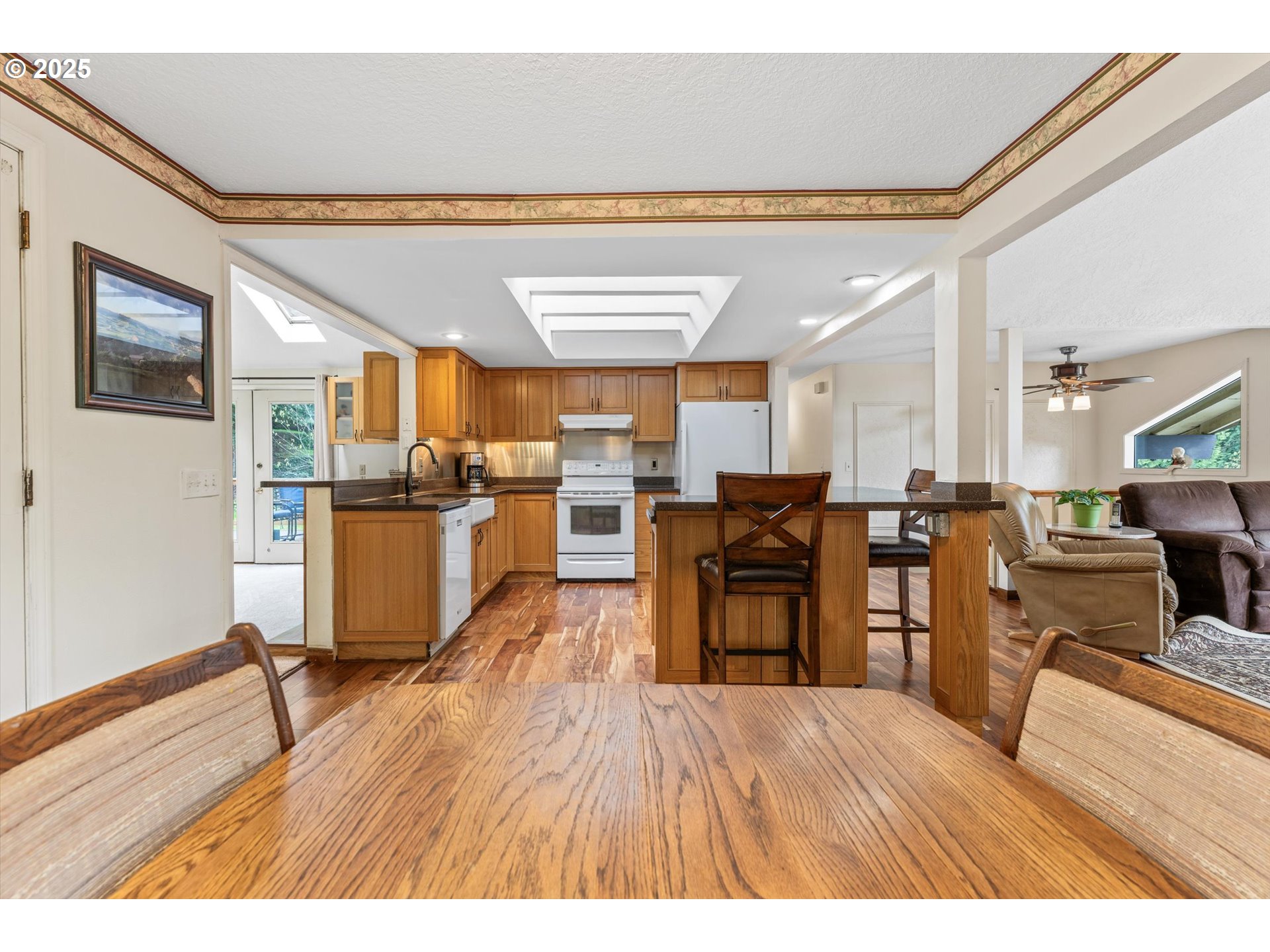 756 Southeast 27th Street Gresham, OR 97080 - Photo 9 of 46 a living room with stainless steel appliances kitchen island granite countertop furniture and wooden floor