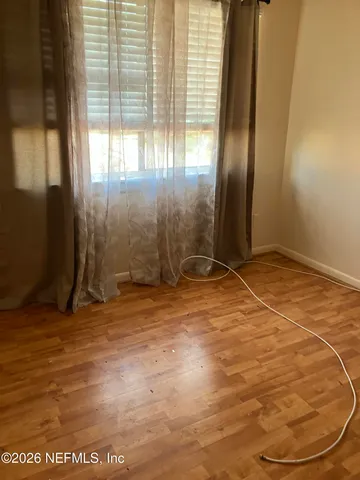 an empty room with a empty space and windows