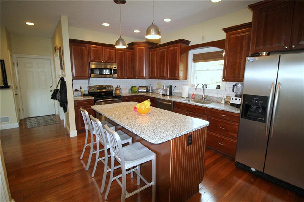 2138 Beams Run Road Jefferson Hills, PA 15025 - Photo 7 of 25 Center island kitchen features stainless steel appliances, new granite countertops, and a new tile backsplash. Located right off the kitchen are the laundry and garage.