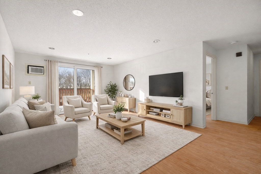 2 Ocean Avenue, Unit 2K Gloucester, MA 01930 - Photo 1 of 26 a living room with furniture and a flat screen tv