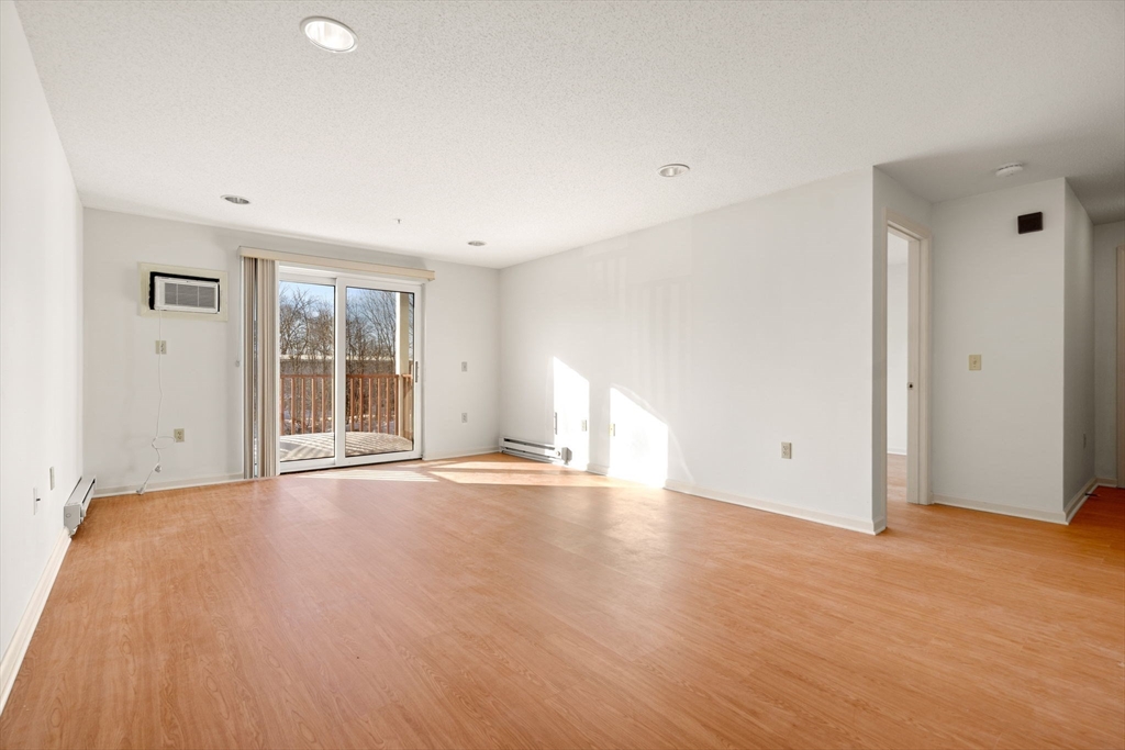 2 Ocean Avenue, Unit 2K Gloucester, MA 01930 - Photo 12 of 26 a view of an empty room with wooden floor and a window