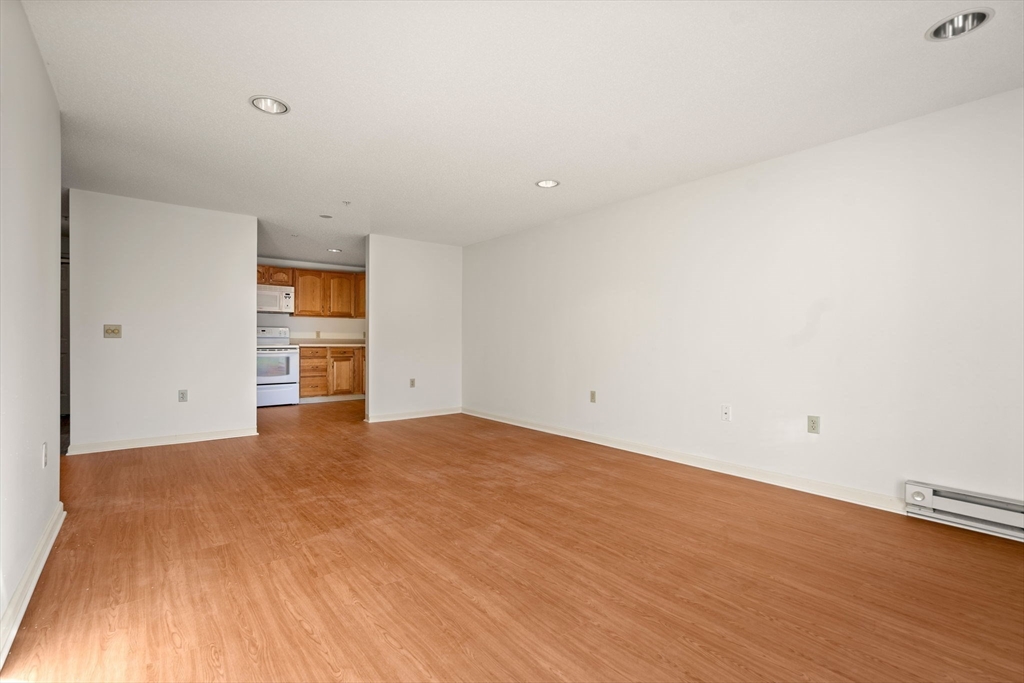 2 Ocean Avenue, Unit 2K Gloucester, MA 01930 - Photo 13 of 26 a view of empty room with wooden floor and windows
