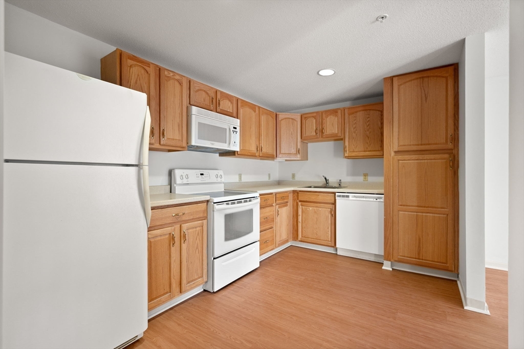2 Ocean Avenue, Unit 2K Gloucester, MA 01930 - Photo 14 of 26 a kitchen with a refrigerator sink and cabinets