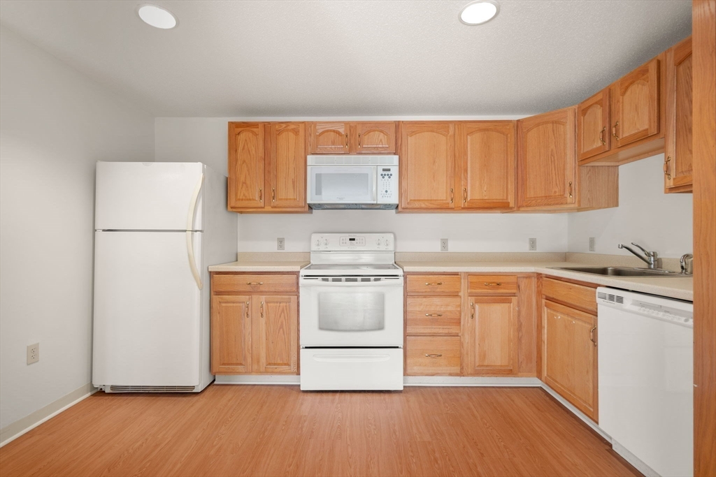 2 Ocean Avenue, Unit 2K Gloucester, MA 01930 - Photo 18 of 26 a kitchen with a refrigerator sink and cabinets