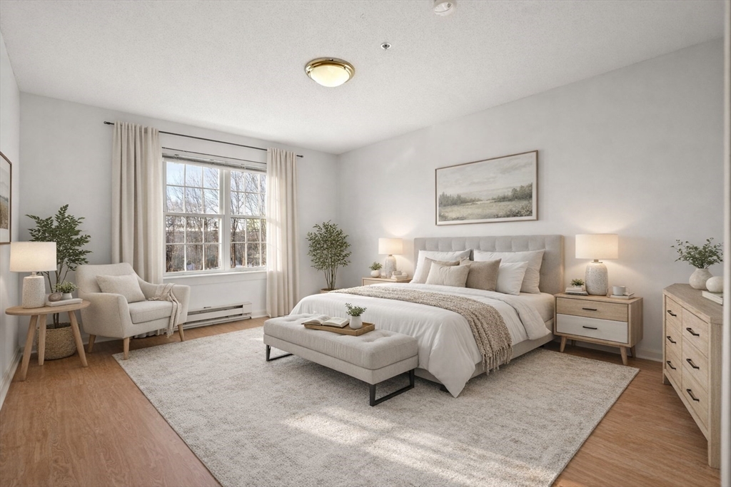 2 Ocean Avenue, Unit 2K Gloucester, MA 01930 - Photo 2 of 26 a spacious bedroom with a bed and glass window