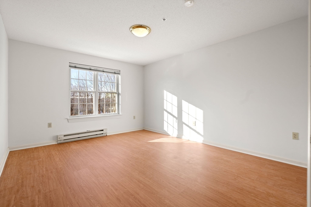 2 Ocean Avenue, Unit 2K Gloucester, MA 01930 - Photo 23 of 26 an empty room with wooden floor and windows