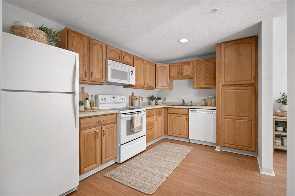 2 Ocean Avenue, Unit 2K Gloucester, MA 01930 - Photo 3 of 26 a kitchen with a refrigerator sink and cabinets