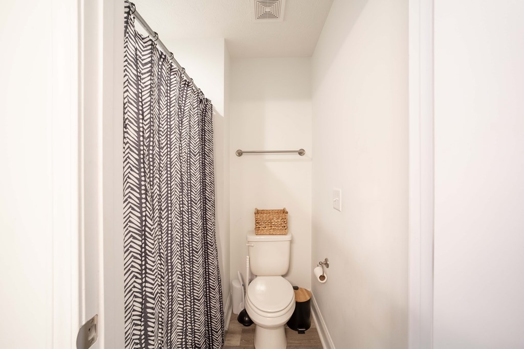 14 Lemon Way Phenix City, AL 36869 - Photo 11 of 13 a bathroom with a toilet and a shower curtain