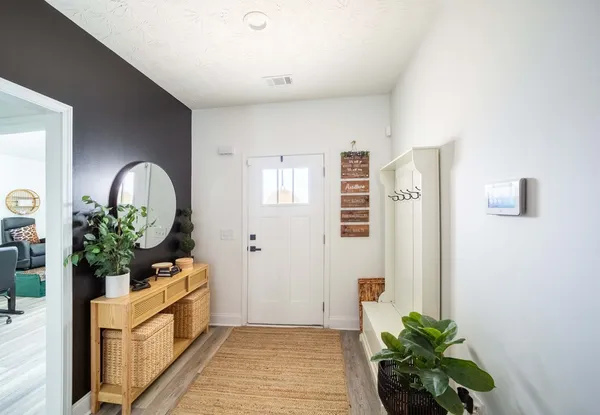 a view of a hallway to a potted plant