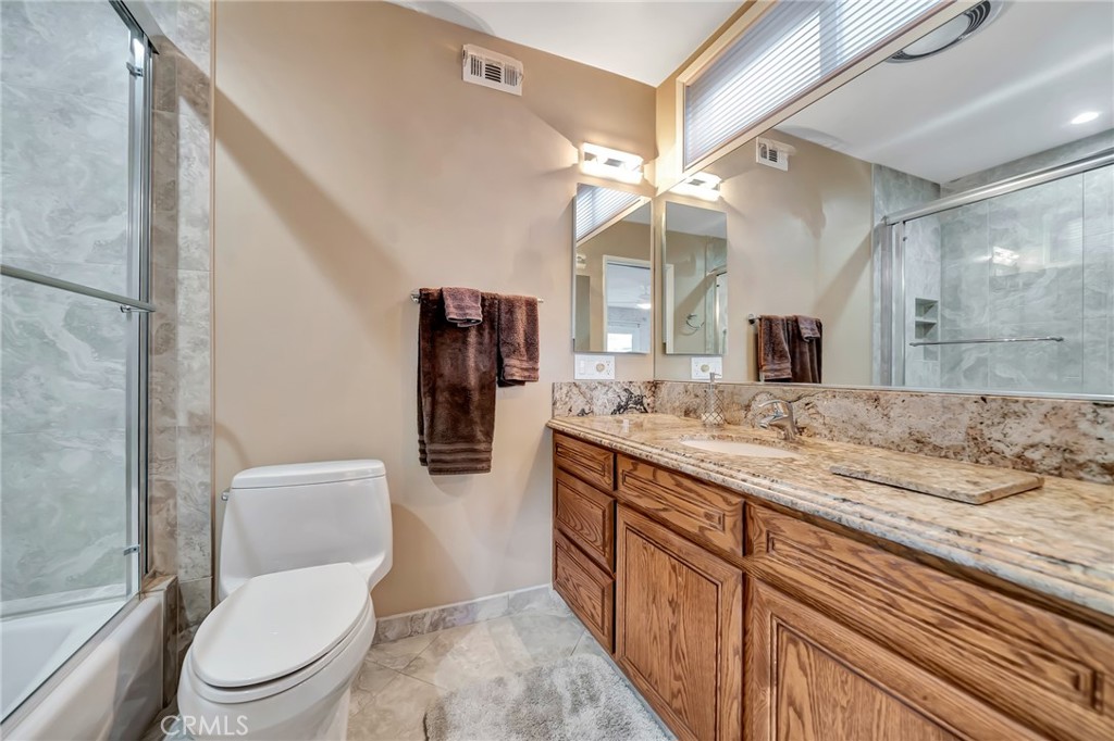 24206 St Edens Circle West Hills, CA 91307 - Photo 16 of 52 a bathroom with a granite countertop toilet sink and mirror