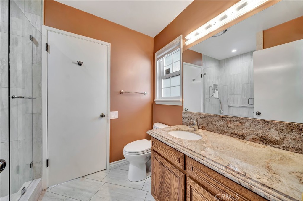 24206 St Edens Circle West Hills, CA 91307 - Photo 22 of 52 a bathroom with a granite countertop sink and a mirror