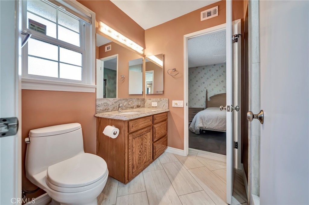 24206 St Edens Circle West Hills, CA 91307 - Photo 23 of 52 a bathroom with a granite countertop toilet sink and mirror