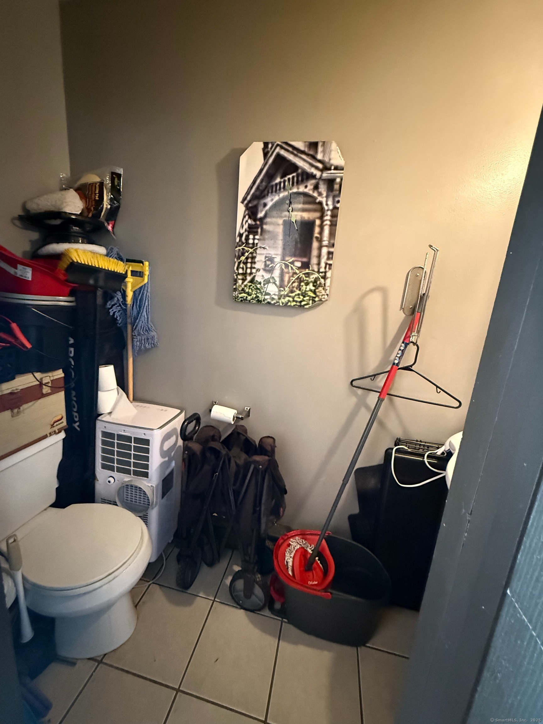 975 Meriden Road, Unit 20 Waterbury, CT 06705 - Photo 6 of 10 a bathroom with a toilet a sink and a mirror