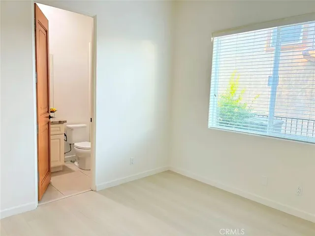 a bathroom with a granite countertop sink mirror vanity and toilet