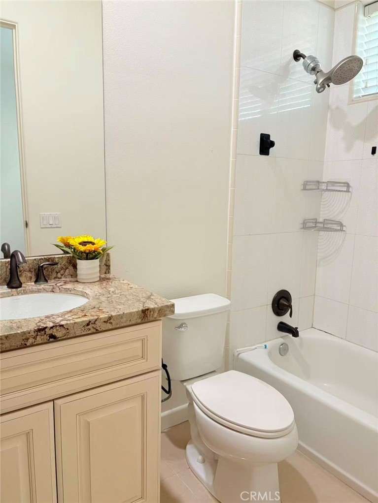 564 Vía Pueblo Riverside, CA 92507 - Photo 12 of 36 a bathroom with a granite countertop sink mirror vanity and toilet