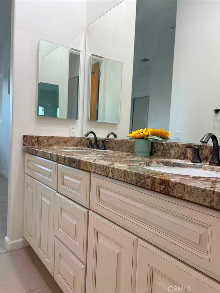 564 Vía Pueblo Riverside, CA 92507 - Photo 18 of 36 a bathroom with a sink and a mirror