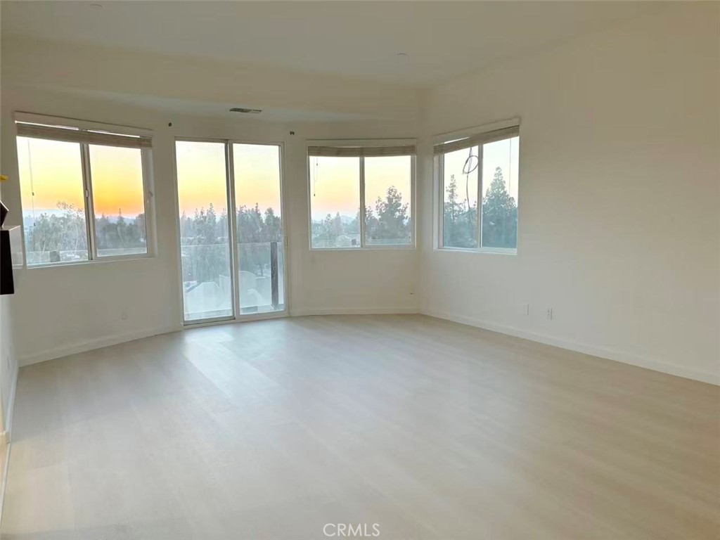 564 Vía Pueblo Riverside, CA 92507 - Photo 23 of 36 an empty room with wooden floor and windows