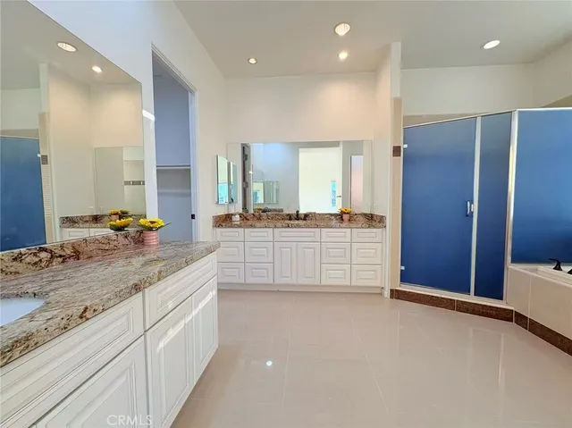 a spacious bathroom with a bathtub and a sink