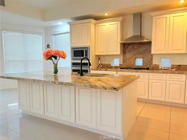 a kitchen with stainless steel appliances granite countertop a sink and cabinets