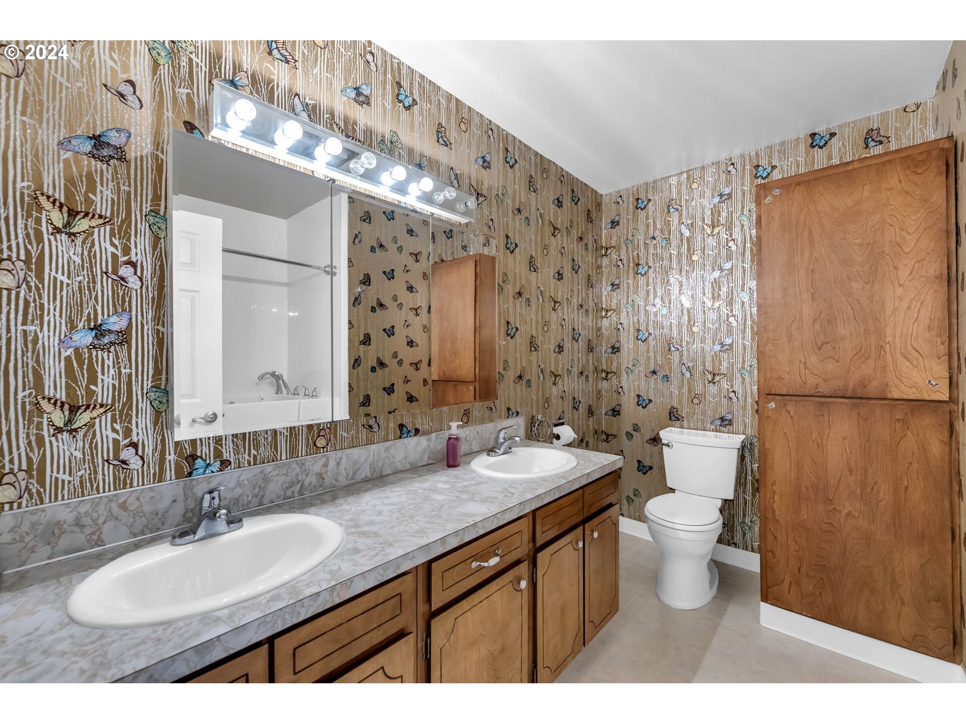 27309 Northeast 29th Avenue Ridgefield, WA 98642 - Photo 18 of 39 a bathroom with a double vanity sink toilet and a mirror