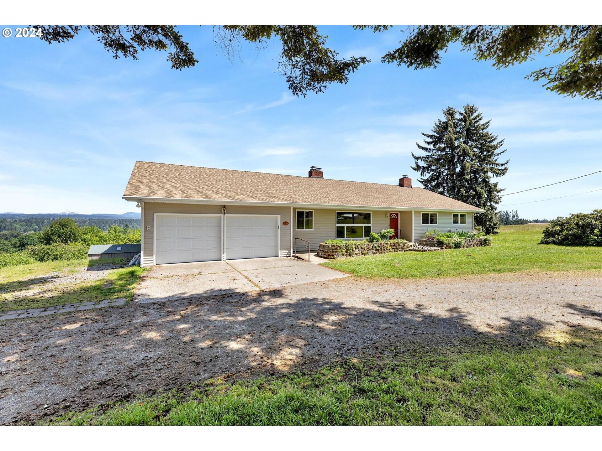 27309 Northeast 29th Avenue Ridgefield, WA 98642 - Photo 2 of 39 a front view of a house with a yard and garage