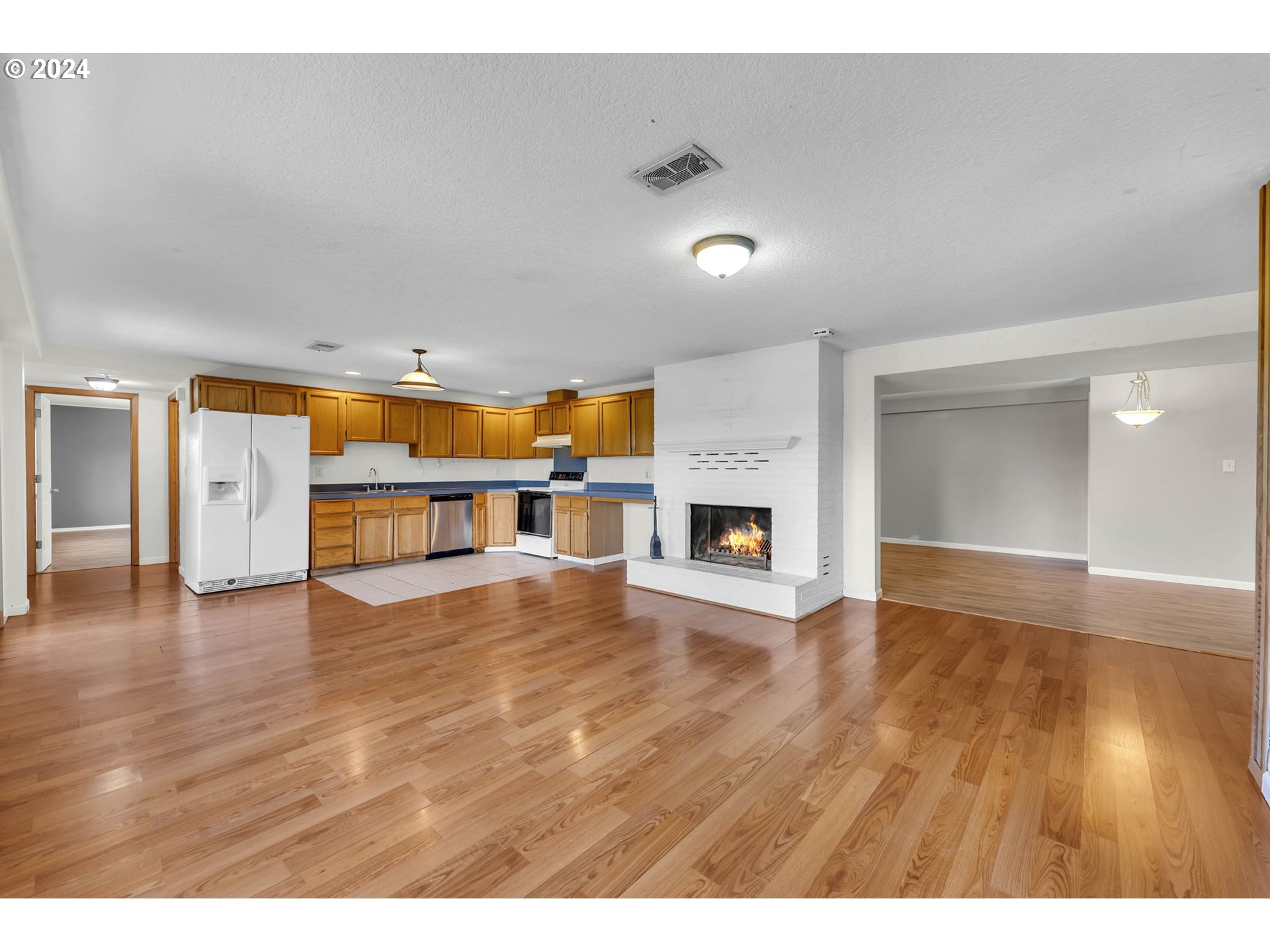 27309 Northeast 29th Avenue Ridgefield, WA 98642 - Photo 24 of 39 a view of an empty room with wooden floor and a fireplace