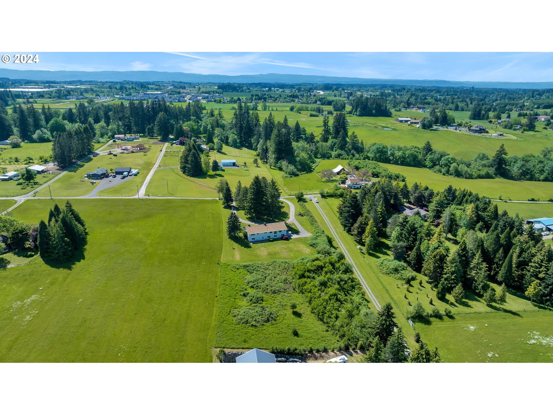 27309 Northeast 29th Avenue Ridgefield, WA 98642 - Photo 34 of 39 a view of a swimming pool and trees in the background