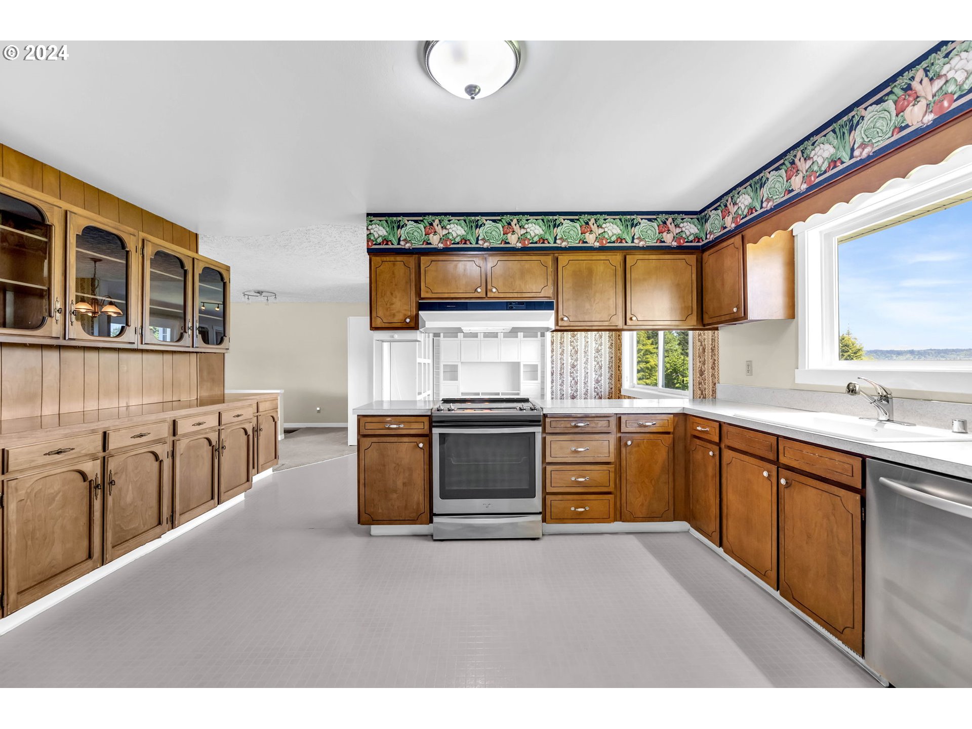 27309 Northeast 29th Avenue Ridgefield, WA 98642 - Photo 8 of 39 a kitchen with stainless steel appliances kitchen island granite countertop a stove a sink and a microwave