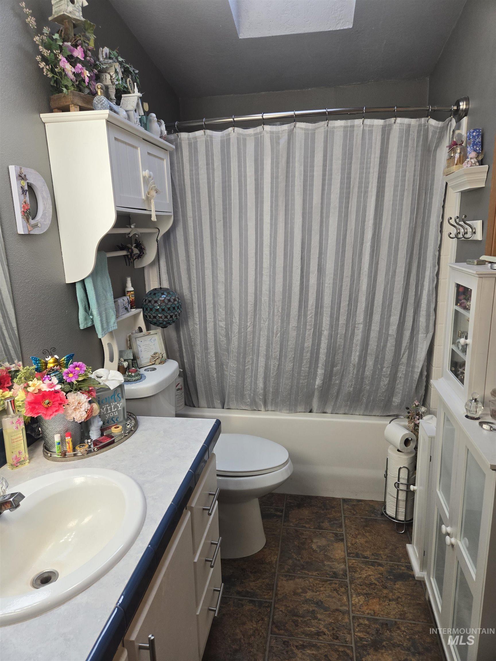 254 Lackey Road Weippe, ID 83553 - Photo 15 of 38 Bathroom featuring vanity, shower / bath combo, and a skylight