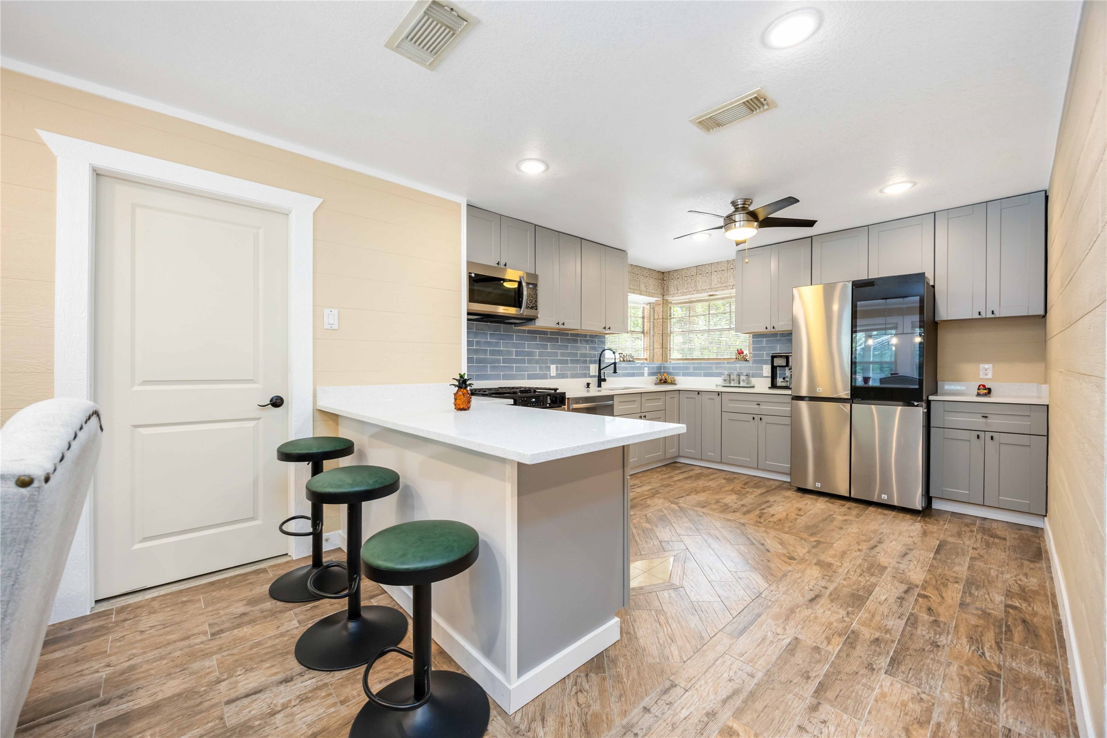 478 Brandon Road Conroe, TX 77302 - Photo 11 of 31 a kitchen with sink cabinets and wooden floor