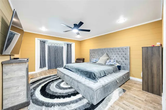 a spacious bedroom with a bed and a couch