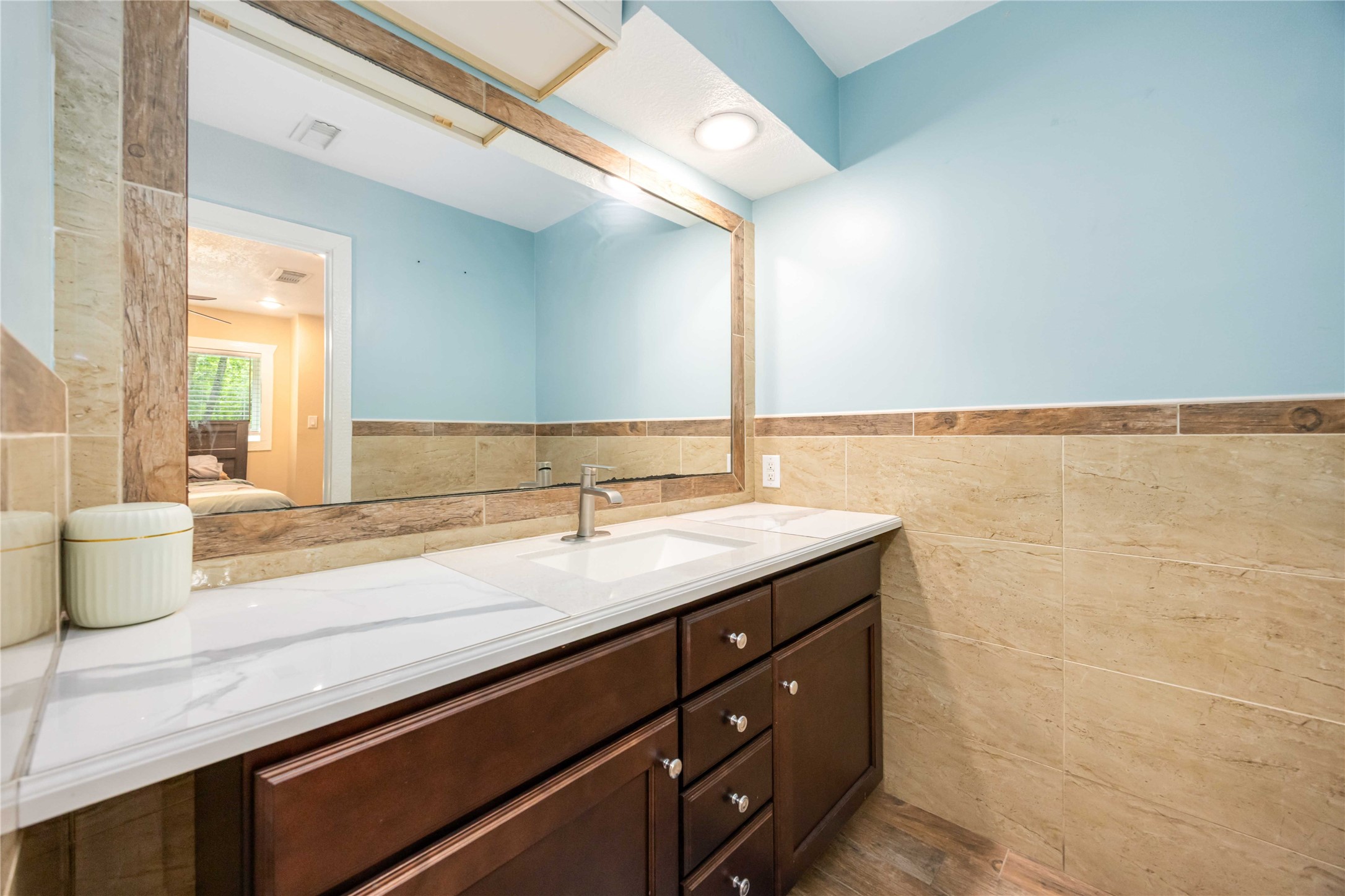 478 Brandon Road Conroe, TX 77302 - Photo 23 of 31 a bathroom with a granite countertop sink and a mirror