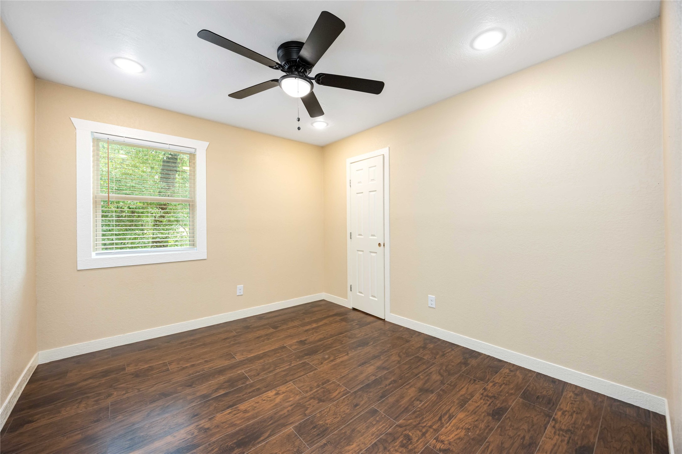 478 Brandon Road Conroe, TX 77302 - Photo 25 of 31 an empty room with wooden floor and windows