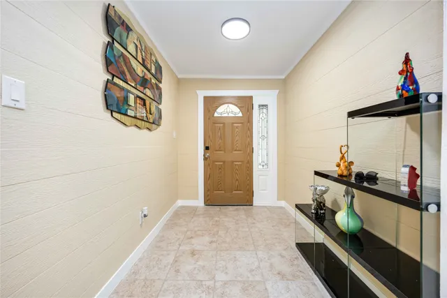 a hallway with a wooden floor and a sink