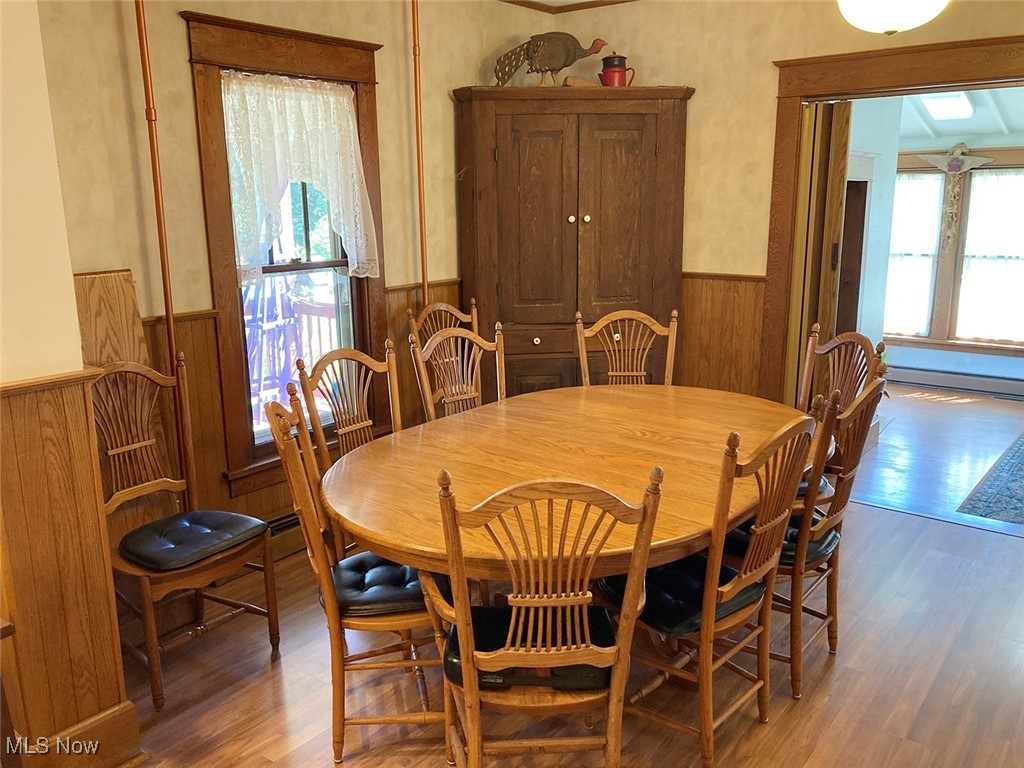 8309 Drake State Line Road Masury, OH 44438 - Photo 26 of 34 Dining room featuring baseboard heating and hardwood / wood-style floors