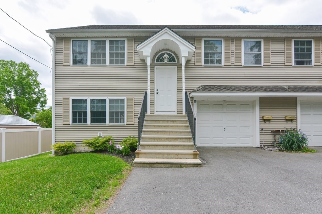 28 Aroostook Street Worcester, MA 01606 - Photo 1 of 40 a front view of a house with a garden and yard