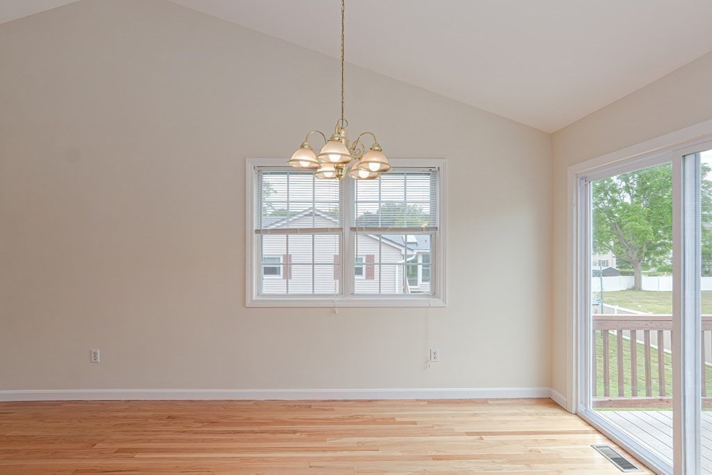 28 Aroostook Street Worcester, MA 01606 - Photo 14 of 40 a view of an empty room with wooden floor and a window