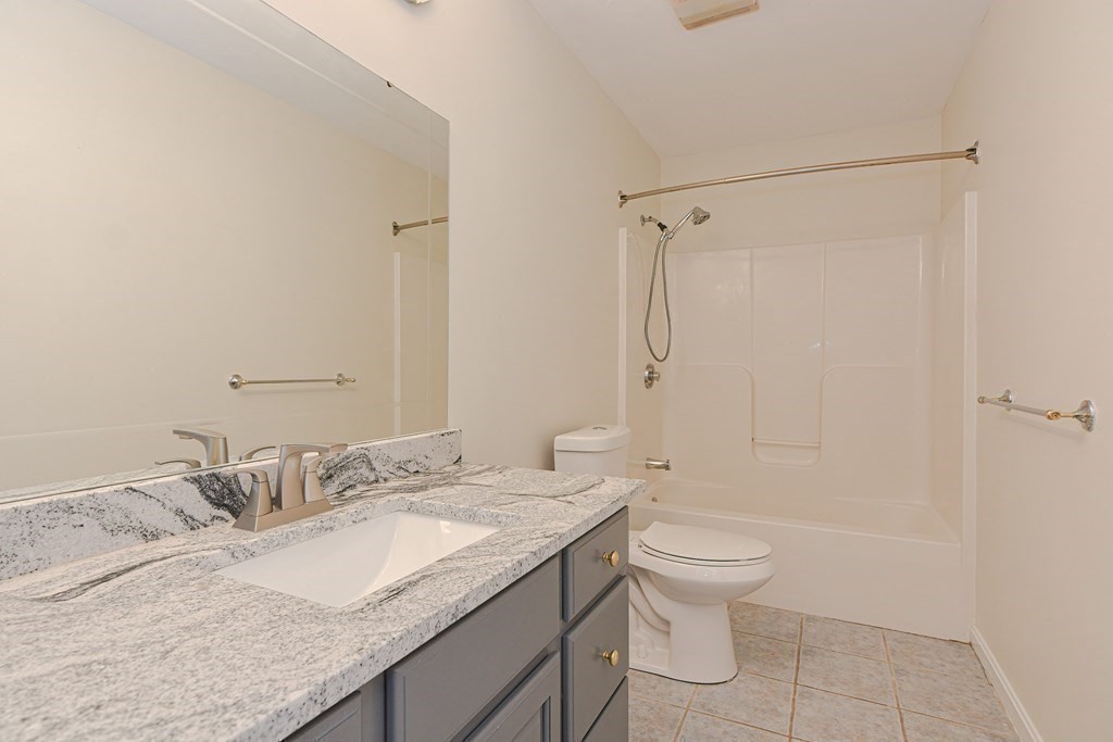 28 Aroostook Street Worcester, MA 01606 - Photo 24 of 40 a bathroom with a granite countertop sink a toilet and shower