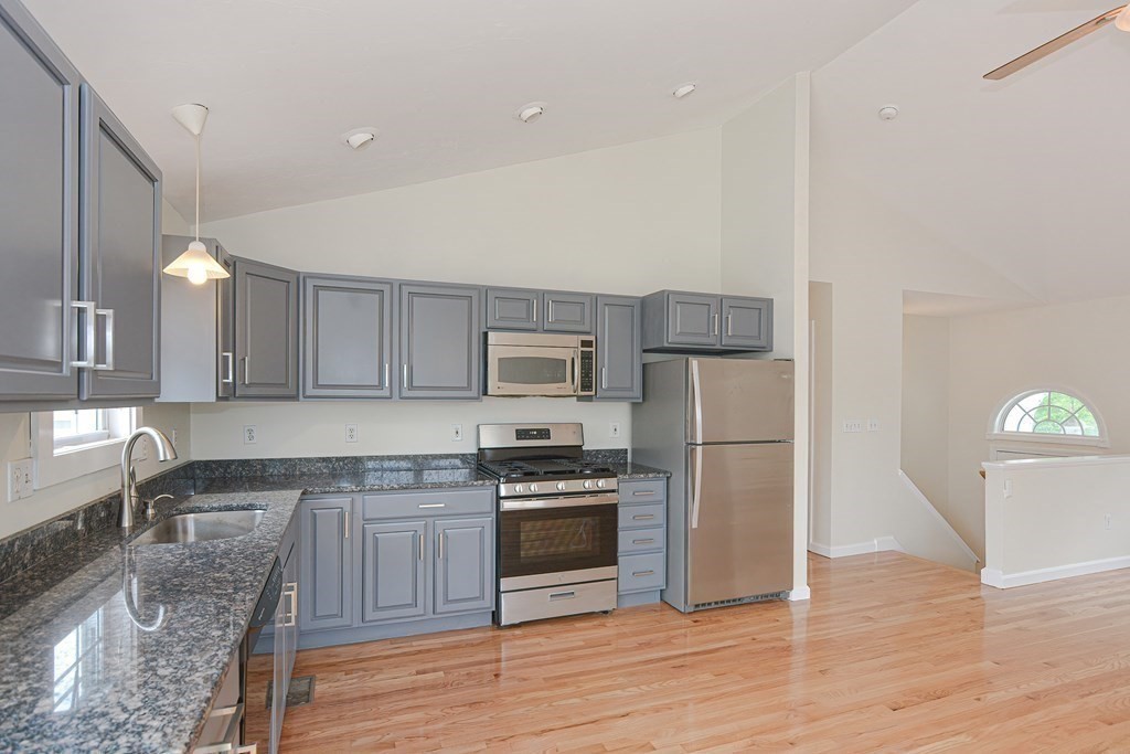 28 Aroostook Street Worcester, MA 01606 - Photo 3 of 40 a kitchen with a refrigerator sink and cabinets
