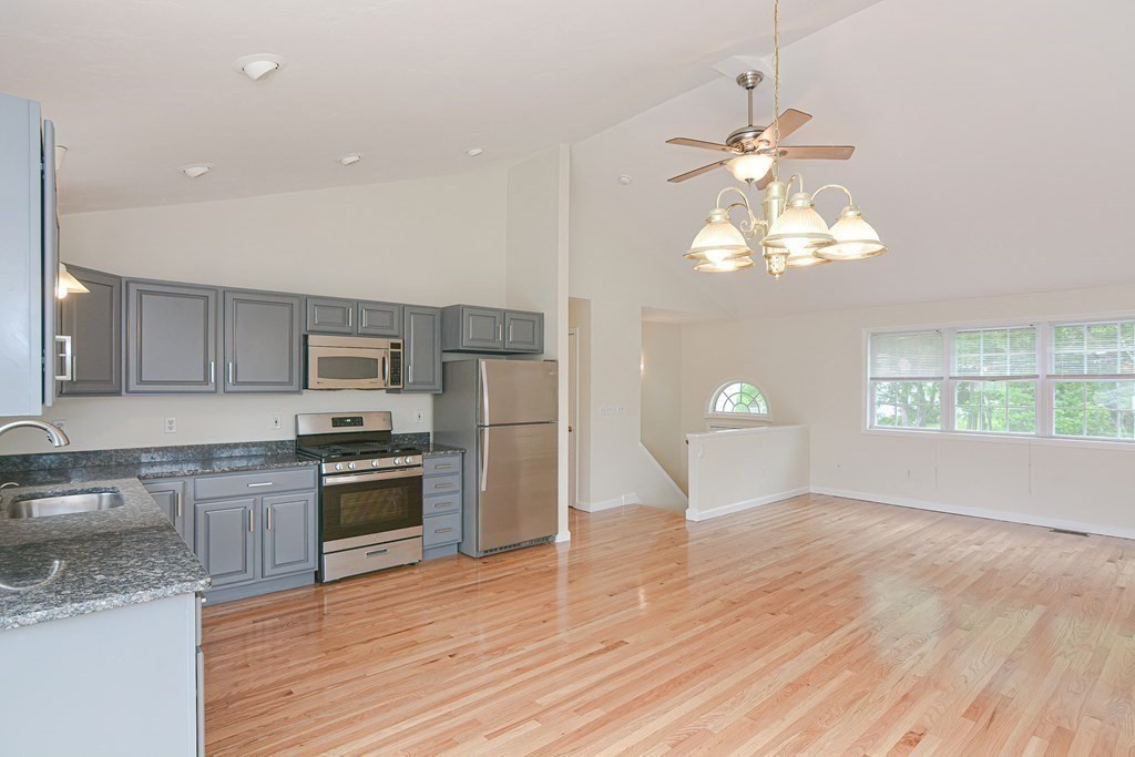 28 Aroostook Street Worcester, MA 01606 - Photo 6 of 40 a view of a kitchen with a sink and dishwasher a stove top oven with wooden floor