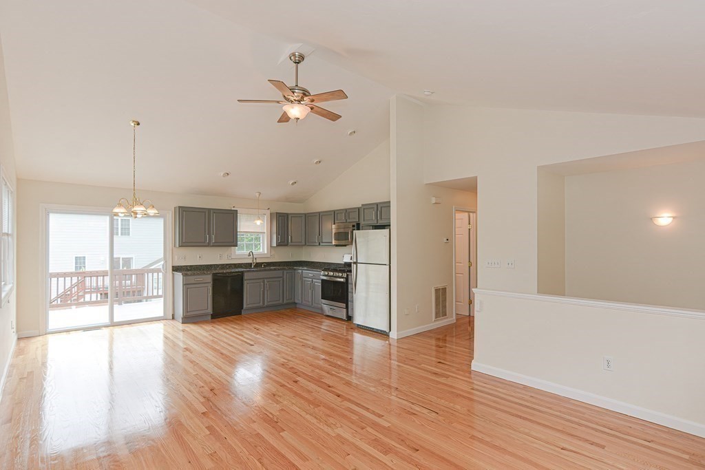28 Aroostook Street Worcester, MA 01606 - Photo 9 of 40 a open kitchen with a refrigerator a sink and a stove