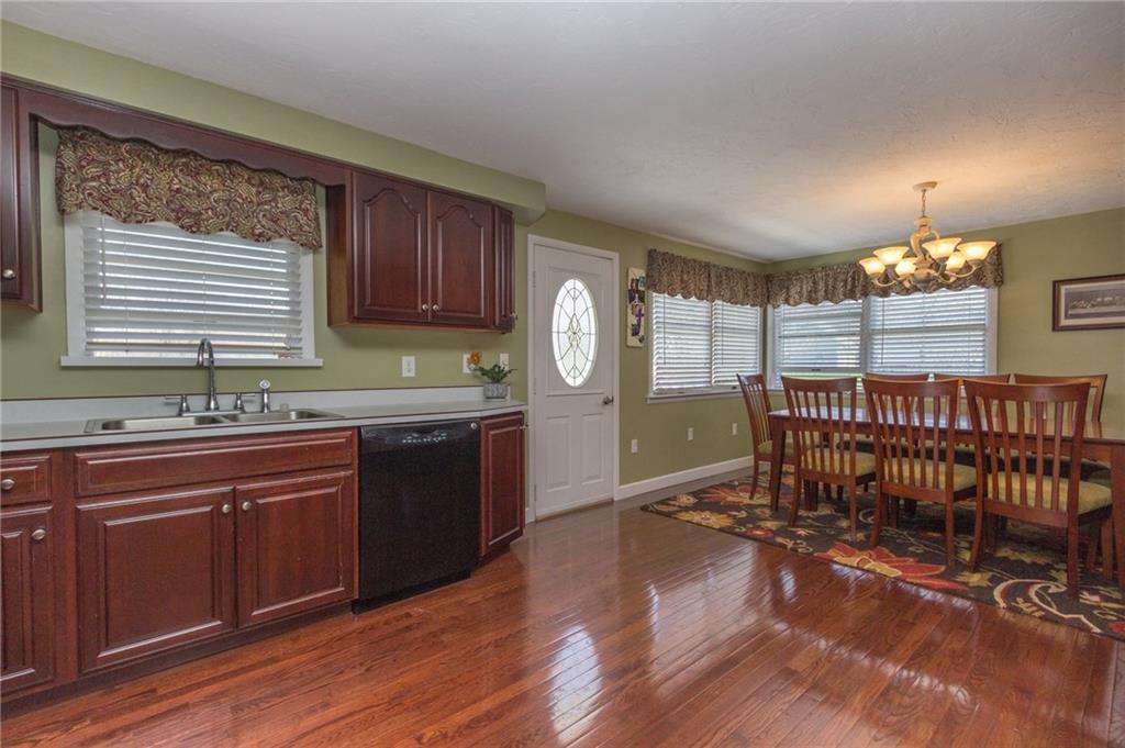 126 Temple Road Monaca, PA 15061 - Photo 3 of 22 Beautiful kitchen with hardwood floors, blinds, black appliances and access to the back deck.