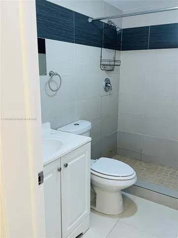 a bathroom with a toilet a sink and shower