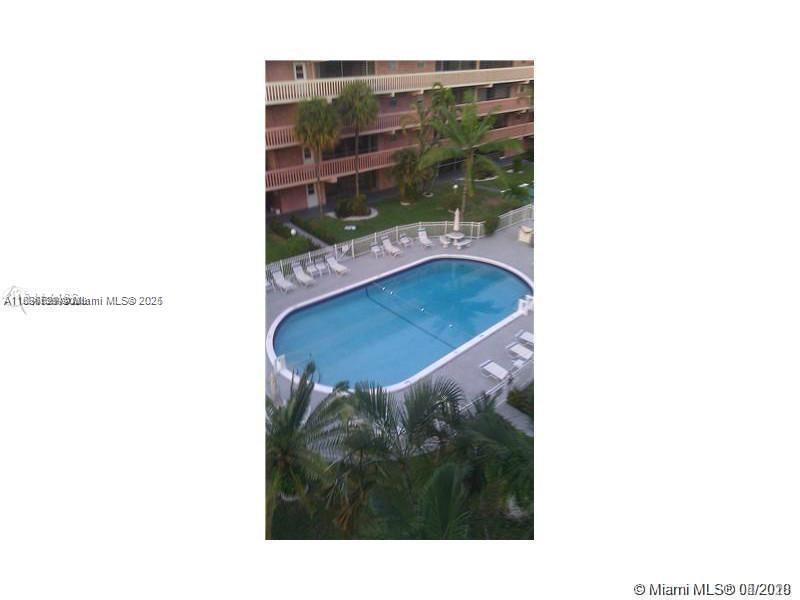 180 Northeast 12th Avenue, Unit 11E Hallandale Beach, FL 33009 - Photo 18 of 22 a picture of a bench in front of a building