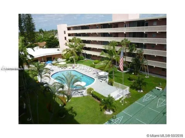 a view of a swimming pool with a yard