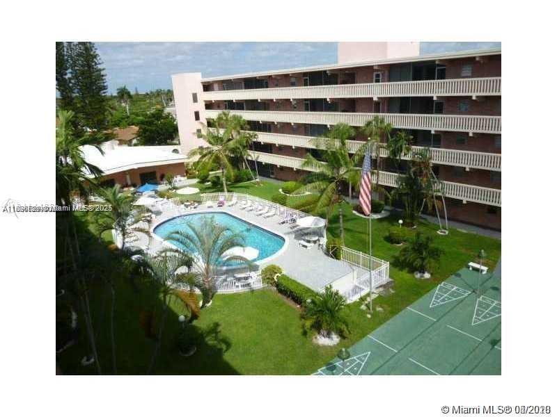 180 Northeast 12th Avenue, Unit 11E Hallandale Beach, FL 33009 - Photo 22 of 22 a view of a swimming pool with a yard