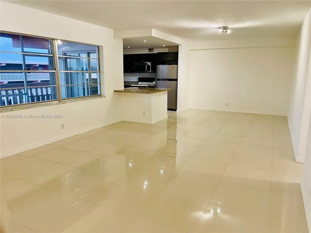 a kitchen with kitchen island a sink a stove and a refrigerator