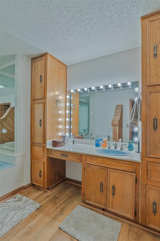 10307 Pirogue Road Oil City, LA 71061 - Photo 22 of 36 a bathroom with a double vanity sink and mirror